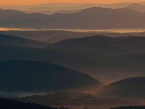 Pre-dawn scene looking across mist-shrouded Appalachian valleys and ridges.