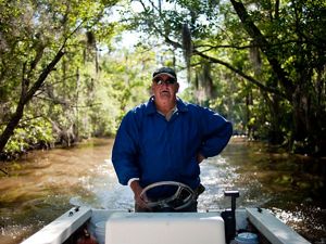 James Holland, a riverkeeper and retired crabber, drives a motorboat.