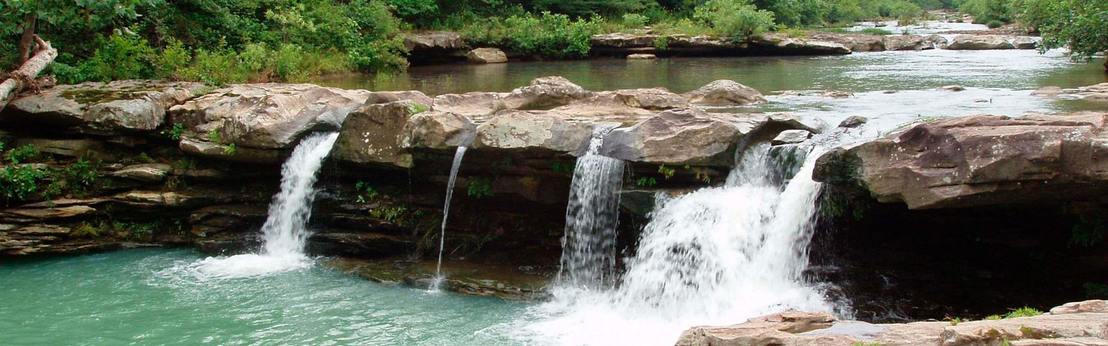 Freshwater waterfall over rocks.