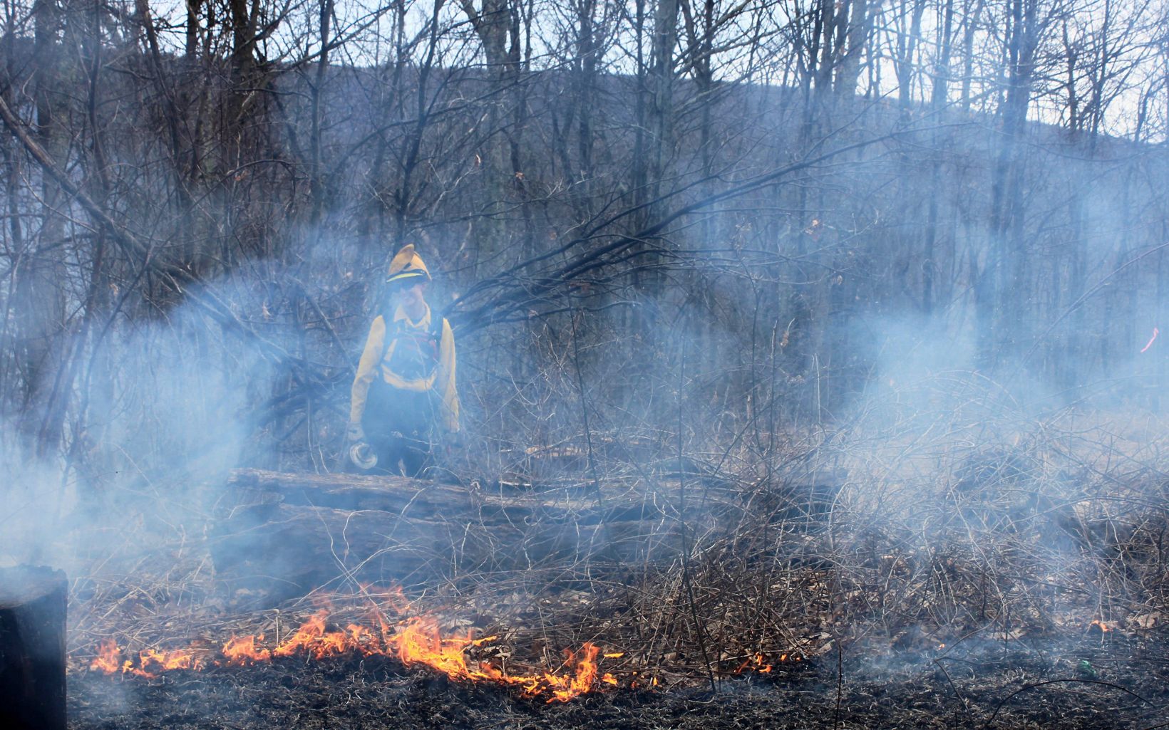 
                
                  Jennifer Dalke Jen Dalke enjoying the smoke and monitoring the fire during the Big Wilson Burn on Warm Springs Mountain. 
                  © Daniel White/TNC
                
              