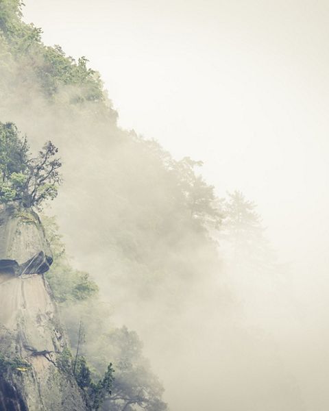 Misty mountain ridge in Laohegou Nature Reserve 