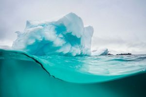Vista por debajo y por encima de la superficie de un glaciar en la Antártida.