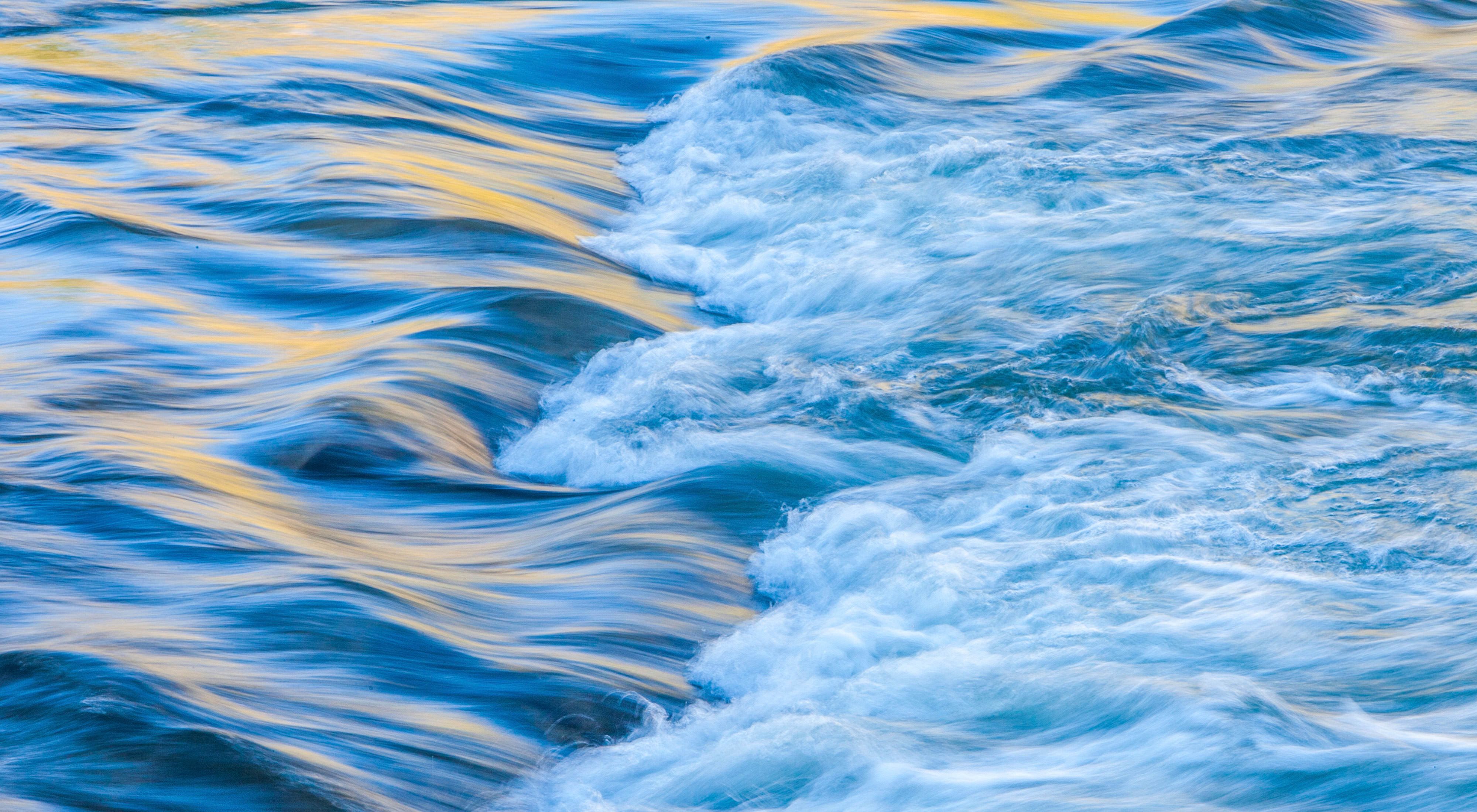  A closeup view of rushing blue water.