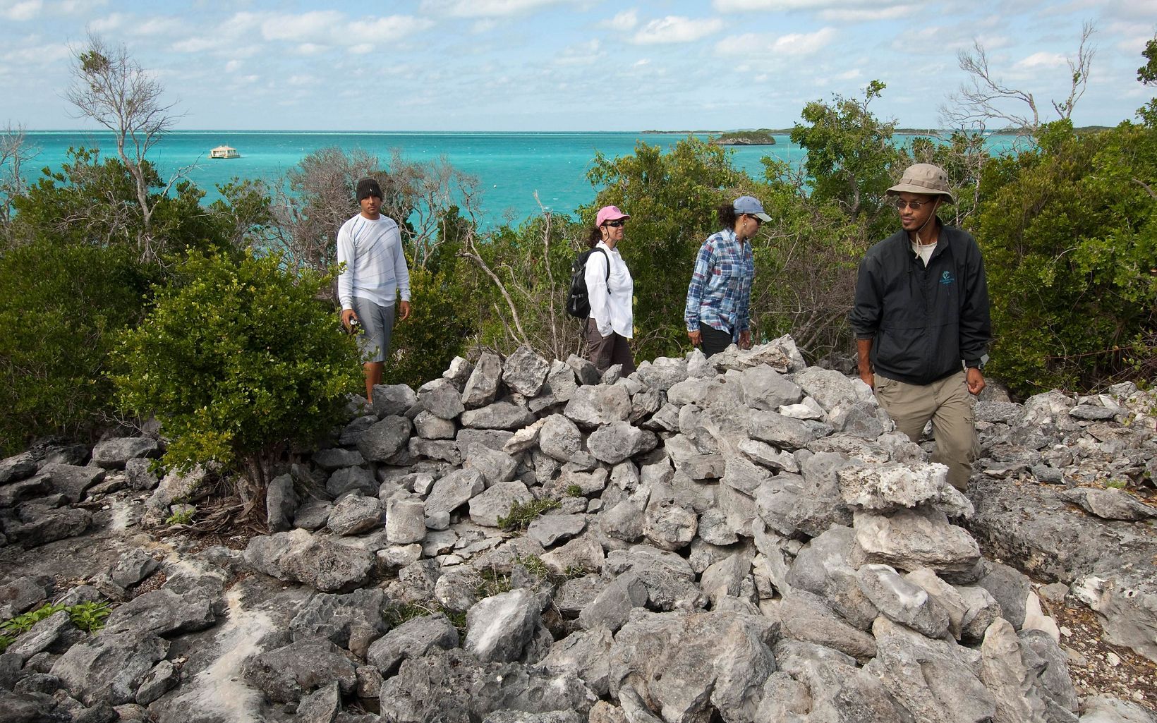 
                
                  Warderick Wells Cay TNC staff explore the ruins of historical structures used as a refuge for British Royalists fleeing America during the American Revolution. 
                  © Mark Godfrey/TNC
                
              