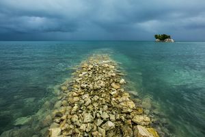 Blue ocean waters under a stormy sky.