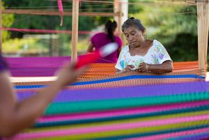 Woman weaving traditional Mayan hammock