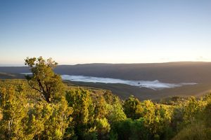 The sun rises over a foggy valley.