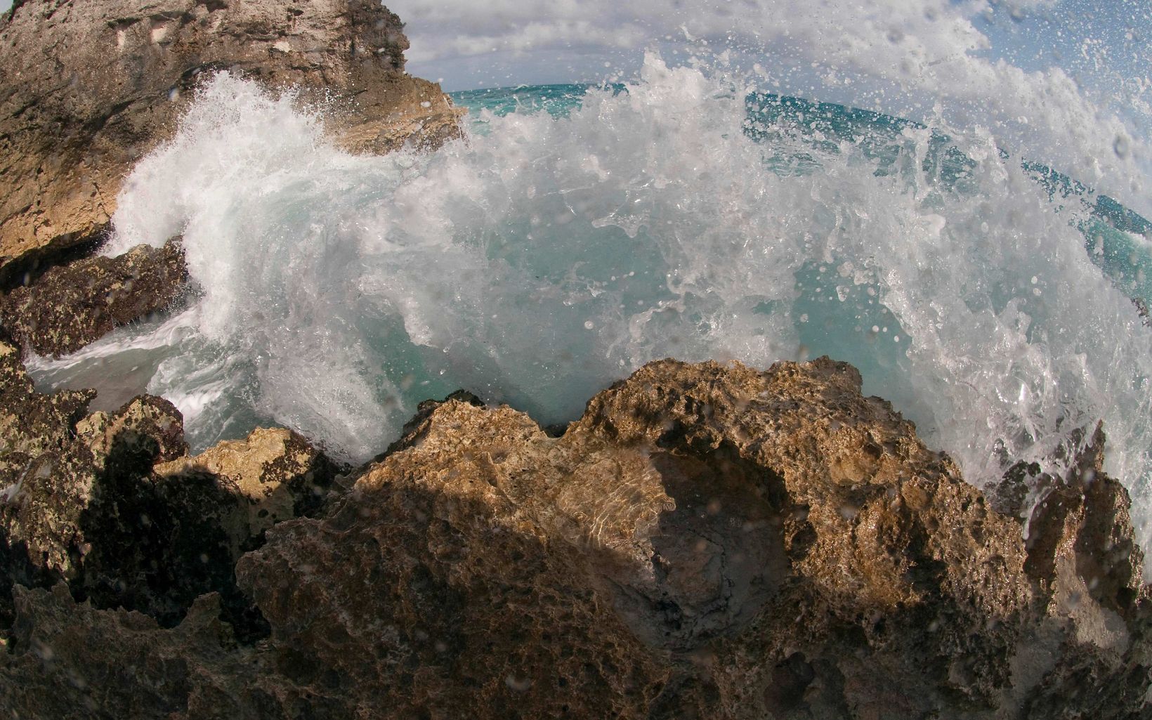 
                
                  Warderick Wells Cay Ocean waves have carved chimneys, columns and blow holes in the limestone. Trails lead up to Boo Boo Hill, named for the way the wind through the rocks sounds like ghosts. 
                  © Mark Godfrey/TNC
                
              