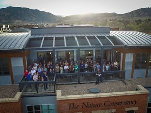 Group of people pictured on balcony at an office building.