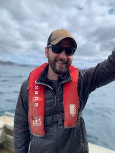 Tom Dempsey on a boat with a life jacket.