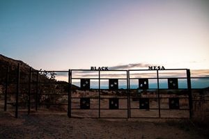 A wide iron gate at the entrance to the Black Mesa trailhead.