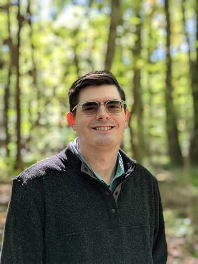 Headshot of Tyler Fisk in a forest 
