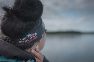 A detail of Mary's headband, which reads, 'land needs guardians.'