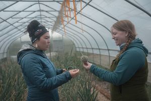 Mary Hostetter and Kylene Blossom interact in one of Igiugig's greenhouses. 
