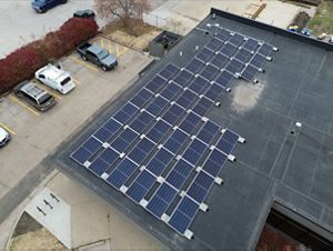 Aerial image of solar panels on the top of a building.