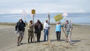 Group of people holding up signs.