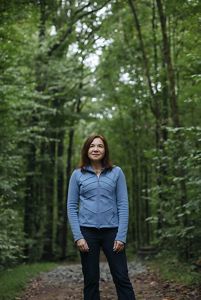 Katharine Hayhoe standing in a forest
