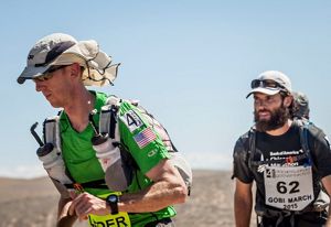 Kyle (left) runs in the Gobi March race as part of the 4 Deserts Ultramarathon series.
