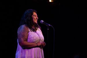 Lylianna Allala speaks into a microphone.