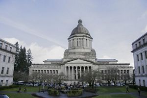 A government building towers against the blue sky. 