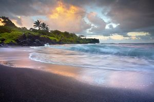 Sunrise on a beach with palm trees. 