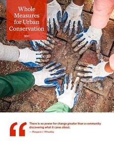 Four people kneel together with their hands placed close to each other on the ground.