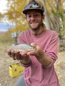Fish biologist holding a juvenile razorback sucker.