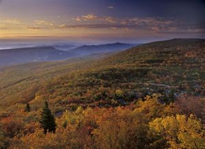 Dawn overlooking green mountains.