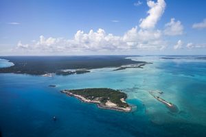 an aerial view of a tropical island and sea.