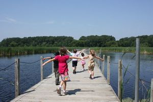 Kids running along the boardwalk at Wood Lake Nature Center.