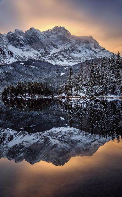 Zugspitze, Germany's tallest mountain, gets lit up by the early morning sun on a cold winter day.